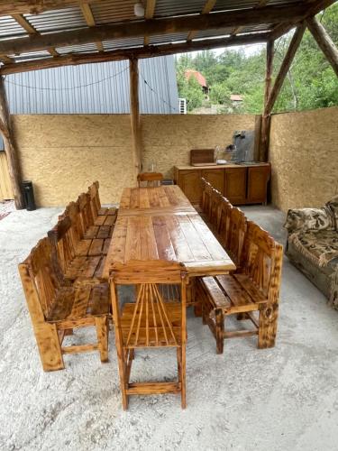 a group of wooden tables and chairs in a room at Hayrapet Asatryan in Arzakan