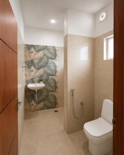 a bathroom with a toilet and a sink at Vedic villa Cherai beach in Cochin