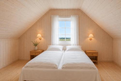 a bedroom with two beds and a window at Rønsholmen brygger in Beian