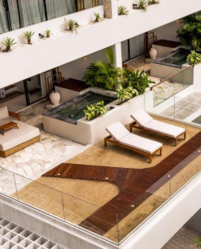 an overhead view of a building with benches and plants at Sore Escape Tumbak Bayuh by Betterplace in Canggu