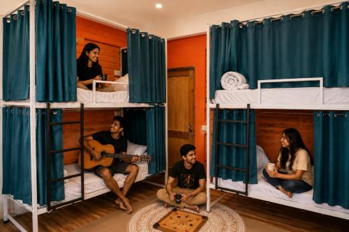 a group of people sitting in bunk beds at Loopin Mcleodganj in McLeod Ganj