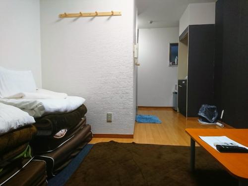 a room with a bed and a couch and a table at Private House Sora / Vacation STAY 1123 in Sakai