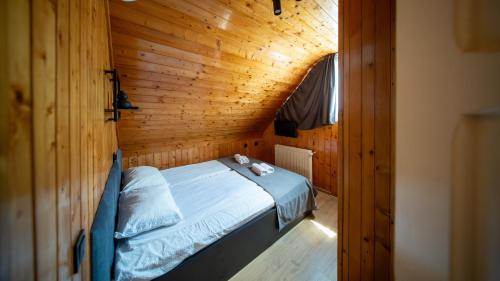 a room with a bed in a wooden cabin at Casa Edy in Sovata