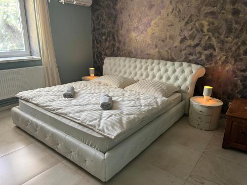 a bed in a bedroom with two candles on it at R Limoli Cozy in Trávnica