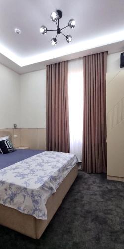 a bedroom with a bed and a window at Maftun Guest House in Samarkand