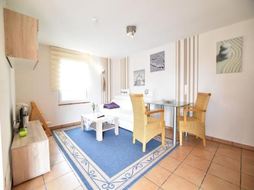 a living room with a dining room table and chairs at Boutique Bungalow in Insel Poel with terrace in Insel Poel