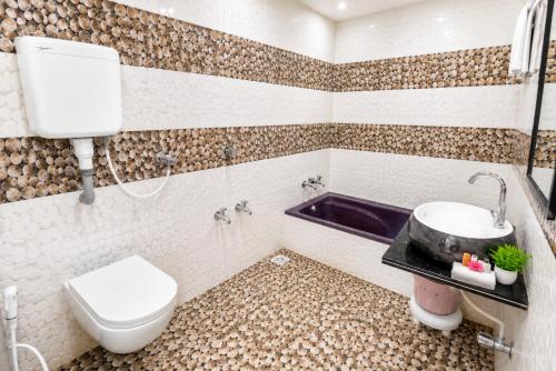 a bathroom with a toilet and a sink at Hotel Bhakti Rajkot I Hotel in Rajkot I Best Hotel in Rajkot in Rajkot