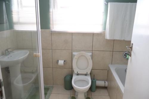 a small bathroom with a toilet and a sink at Nao's Place in Dorchester Heights 