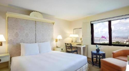 a hotel room with a bed and a window at Regency Art Hotel in Macau