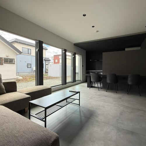 a living room with a couch and a table at U suzukou in Asahikawa
