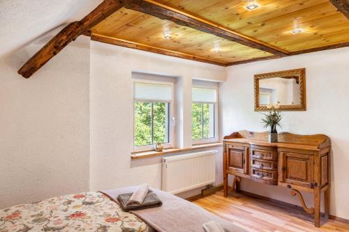 a bedroom with a bed and a dresser and a window at Ferienwohnung Schwarzmühle 3 in Neuer Anbau