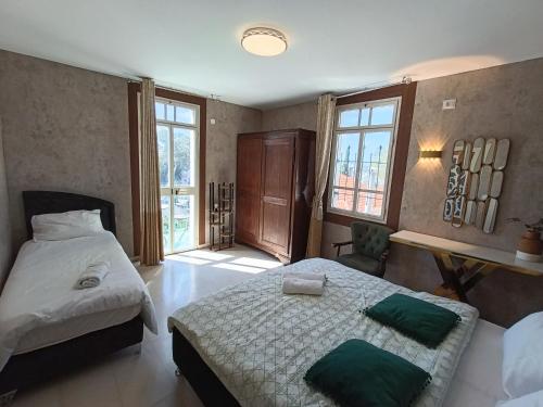 a bedroom with two beds with green pillows at Diamond Luxury Apartment - Haifa in Haifa
