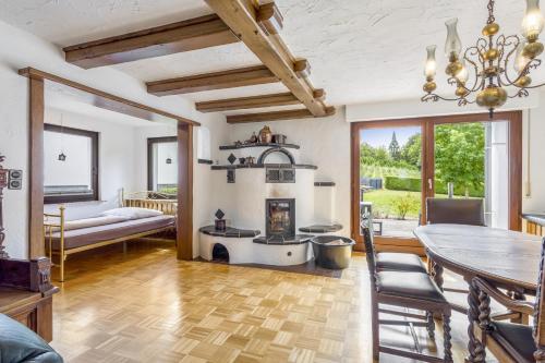 a living room with a fireplace and a table at Fewo Wrede am Sauerland-Radring 1 in Wenholthausen