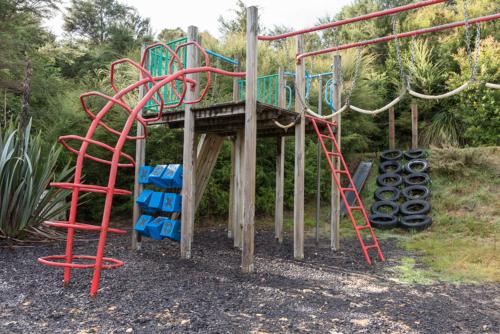 a play park with a playground with a play system at Russell-Orongo Bay Holiday Park in Russell
