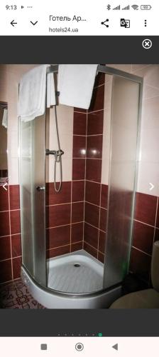 a shower in a bathroom with red tile at Готель Аркан in Kolomiya