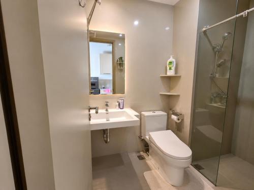 a bathroom with a toilet and a sink and a shower at Modern studio with a stûnning view at 32 floor in Jakarta