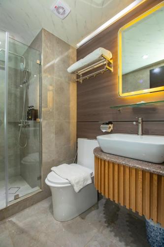 a bathroom with a sink and a toilet and a shower at EGI Cebu Resort and Hotel in Maribago