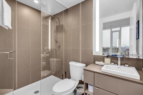 a bathroom with a toilet and a shower and a sink at Toronto Skyline Center Hotel in Toronto