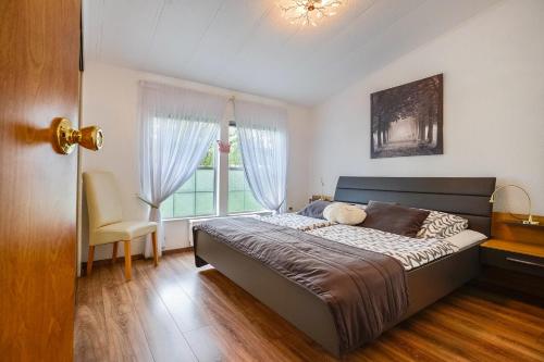 a bedroom with a large bed and a window at Ferienhaus Rauchfangswerder in Berlin
