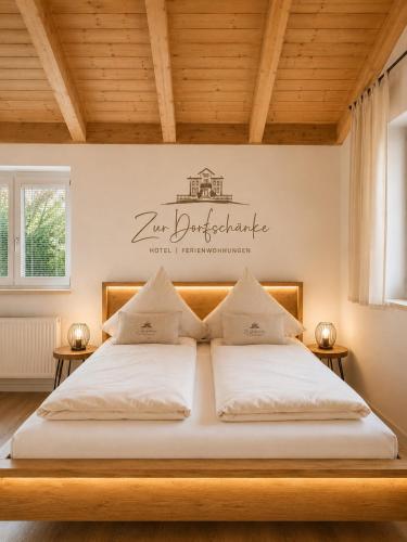 a bedroom with two beds and a sign on the wall at Dorfschänke DEGGENDORF Hotel & Apartmenthaus in Deggendorf