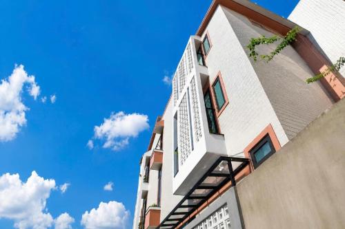 a tall white building with a blue sky in the background at 2MINZ Homestay in Thôn An Hòa