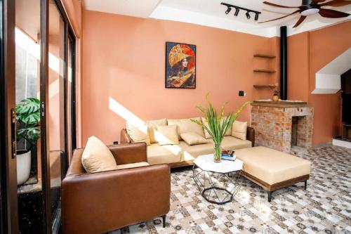 a living room with a couch and a fireplace at 2MINZ Homestay in Thôn An Hòa