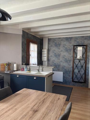 a kitchen with a wooden table in a room at LOGEMENT ENTIER Tilleul Suite in Fléac