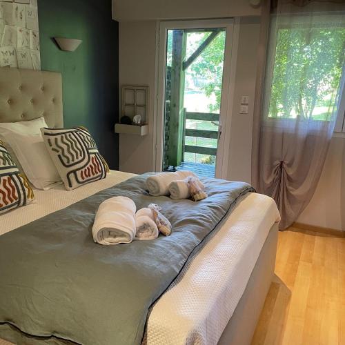 a dog laying on a bed in a bedroom at LOGEMENT ENTIER Tilleul Suite in Fléac