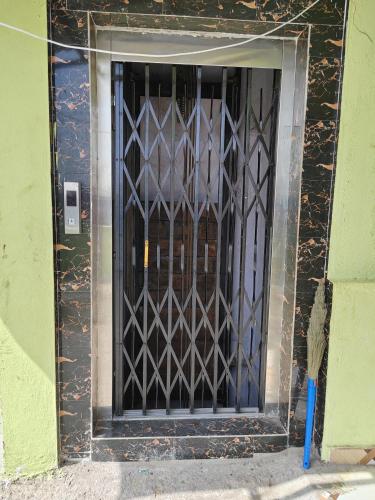 a door with a iron gate on the side of a building at Harekrishna Nilayam in Vemalwāda