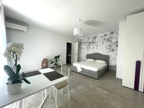 a bedroom with a bed and a table and a dining room at Villa Nina in Lagosanto