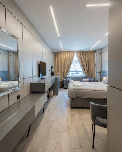 a bedroom with two beds and a large window at 7Boys Hotel in Amman