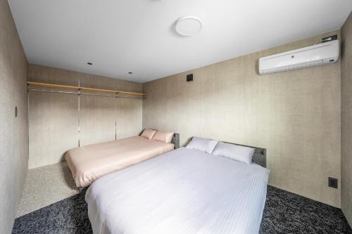 a bedroom with a large white bed in it at S - Vacation STAY 20201 in Asahikawa