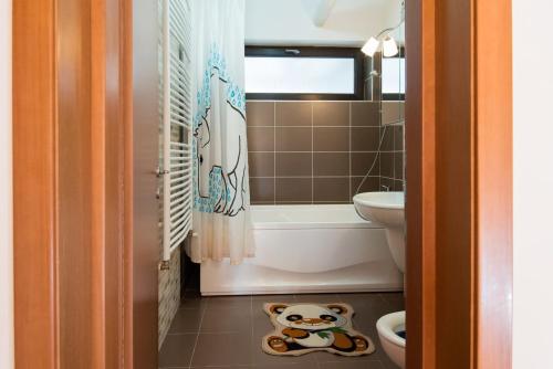 a small bathroom with a monkey toy on the floor at Sia Mountain Apartment in Predeal