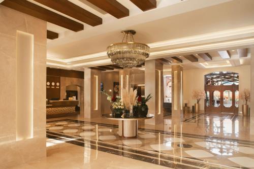 a lobby of a hotel with a chandelier at Charmillion Gardens Aquapark in Sharm El Sheikh