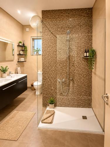 a bathroom with a shower with a glass door at Valletta Triton Apartment in Valletta