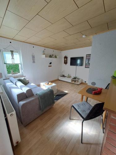 a living room with a couch and a flat screen tv at Ferienhaus Hilde in Sangerhausen