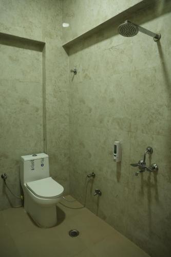a bathroom with a toilet and a shower at Shree Krishna Hotel & Restraunt in Pātolī