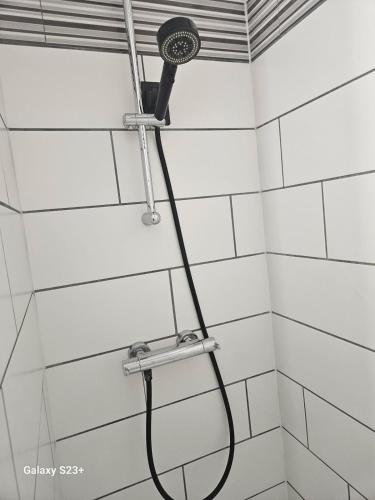 a shower with a shower head in a bathroom at Studio 2 personnes in Cucq