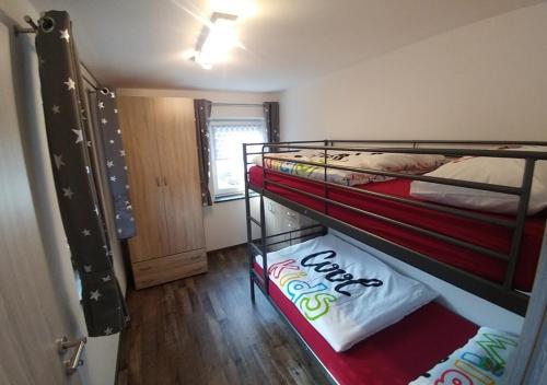 a small room with two bunk beds in it at Ferienhaus Bumblebee im Allgäu in Eggenthal
