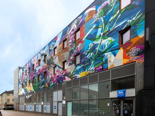 a building with a colorful mural on the side of it at ibis budget Swindon Town Centre in Swindon