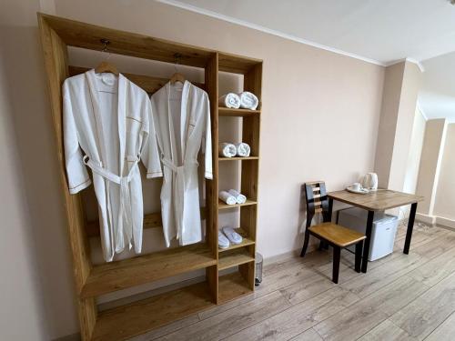 a room with a wooden shelf with white clothes at DEMAL Mountain Resort in Alamedin