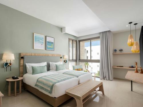 a bedroom with a large bed and a large window at Atlas Essaouira Riad Resort in Essaouira