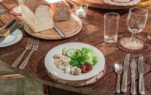 a wooden table with a plate of food on it at Rangala House in Digana