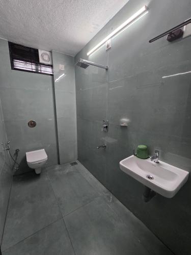 a bathroom with a sink and a toilet at Kukke Sai Skanda in Subrahmanya