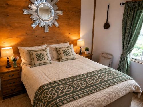 a bedroom with a large bed with a mirror on the wall at Donegal Oceanview Retreat in Drumaville