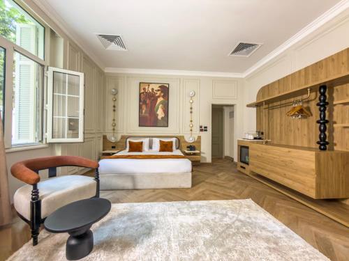 a hotel room with two beds and a chair at AJIRA Zamalek Hotel in Cairo