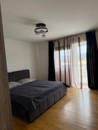 a bedroom with a bed and a large window at 2 Schlafzimmer Apartment Bergland 