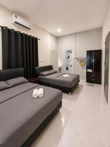 a hospital room with two beds and a room with at Casaria Beach in Paka