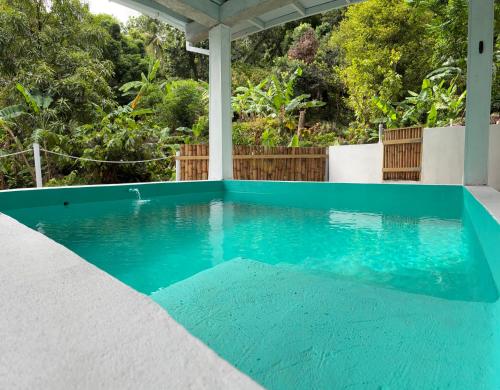 a swimming pool on a house with blue water at Cinnamon Cottage - Peaceful retreat in nature in Soufrière