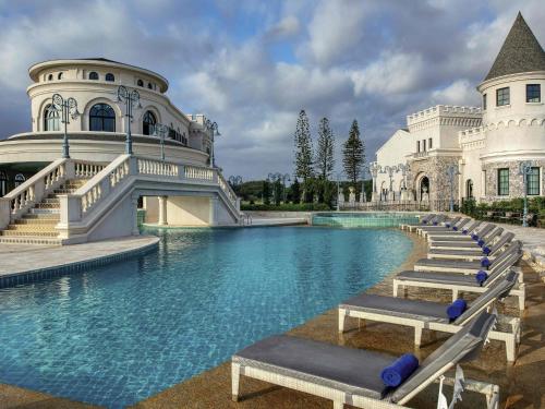 a mansion with a pool in front of it at Mövenpick Resort Khao Yai in Ban Wang Sai